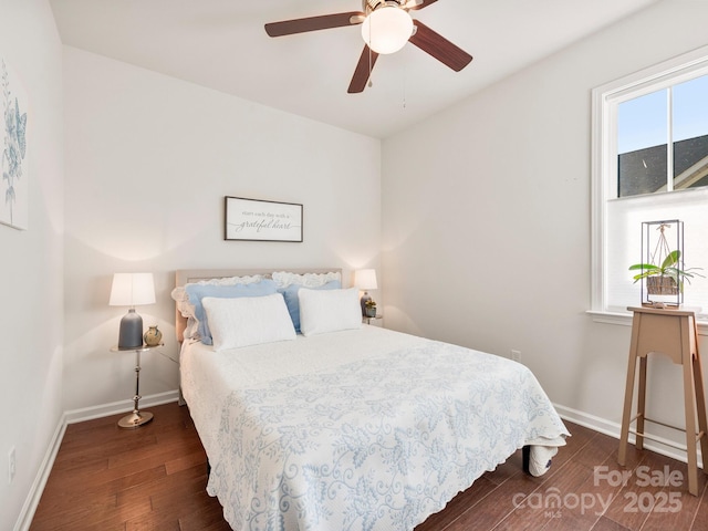 bedroom featuring multiple windows, ceiling fan, and dark wood-type flooring