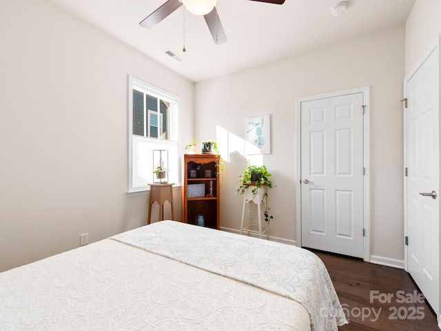 bedroom with ceiling fan and dark hardwood / wood-style floors