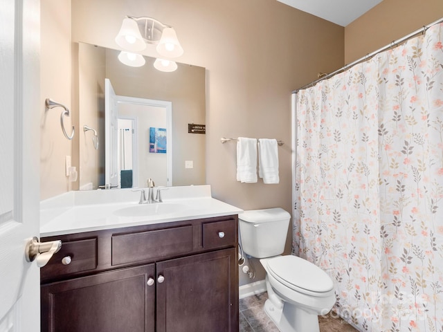 bathroom featuring tile patterned floors, vanity, and toilet