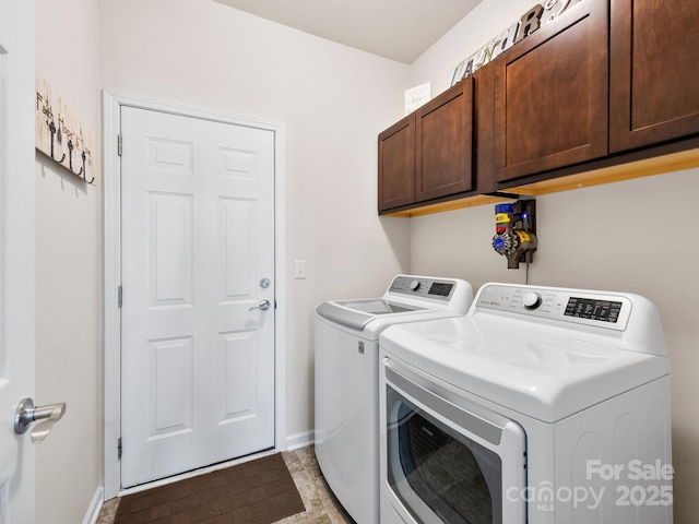 washroom with cabinets and washing machine and clothes dryer