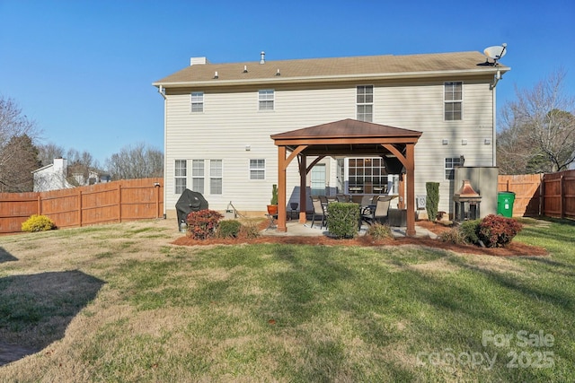 back of property featuring a gazebo, a patio area, and a lawn