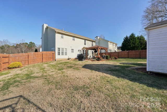 back of house with a gazebo and a yard