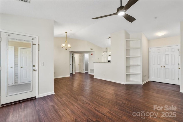 unfurnished living room with built in shelves, dark hardwood / wood-style floors, ceiling fan with notable chandelier, and vaulted ceiling