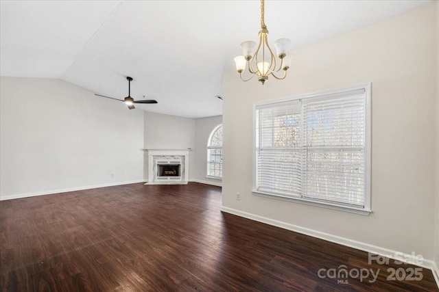 unfurnished living room featuring a high end fireplace, ceiling fan with notable chandelier, hardwood / wood-style flooring, and lofted ceiling