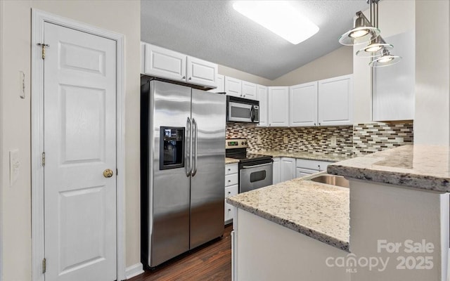 kitchen with backsplash, light stone counters, stainless steel appliances, decorative light fixtures, and white cabinetry