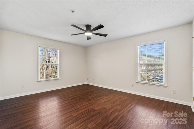 unfurnished room featuring dark hardwood / wood-style floors, ceiling fan, and a textured ceiling