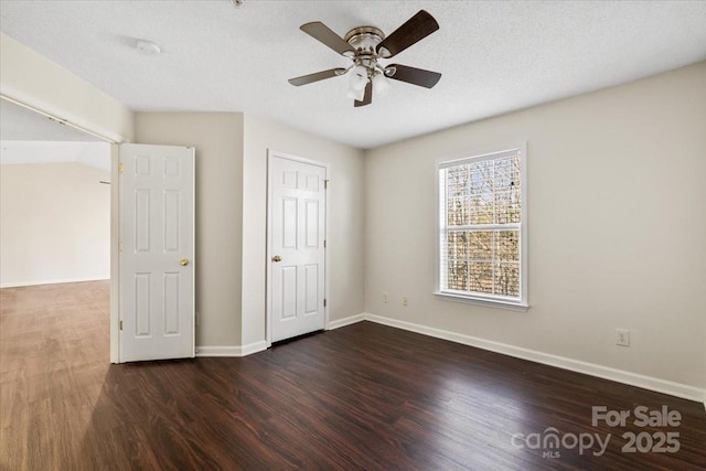 unfurnished bedroom featuring ceiling fan, dark hardwood / wood-style flooring, and a textured ceiling