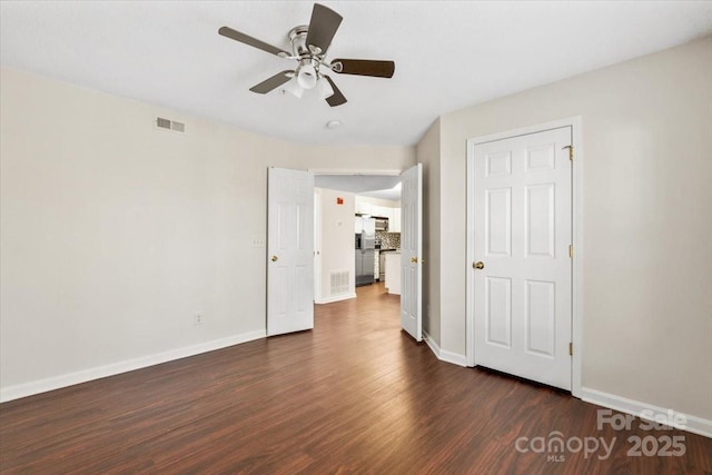 unfurnished room featuring ceiling fan and dark hardwood / wood-style flooring