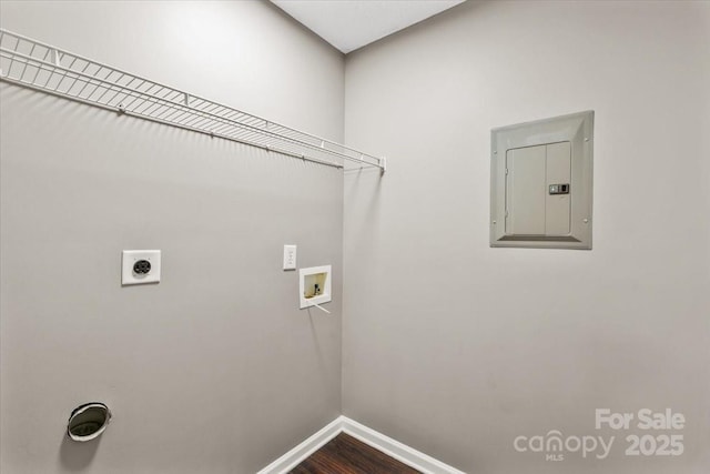 clothes washing area featuring electric panel, hardwood / wood-style flooring, hookup for a washing machine, and hookup for an electric dryer