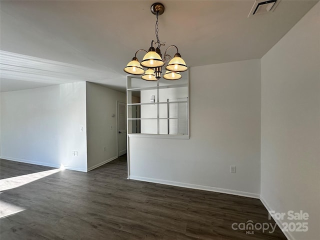 unfurnished dining area featuring dark hardwood / wood-style floors and a notable chandelier