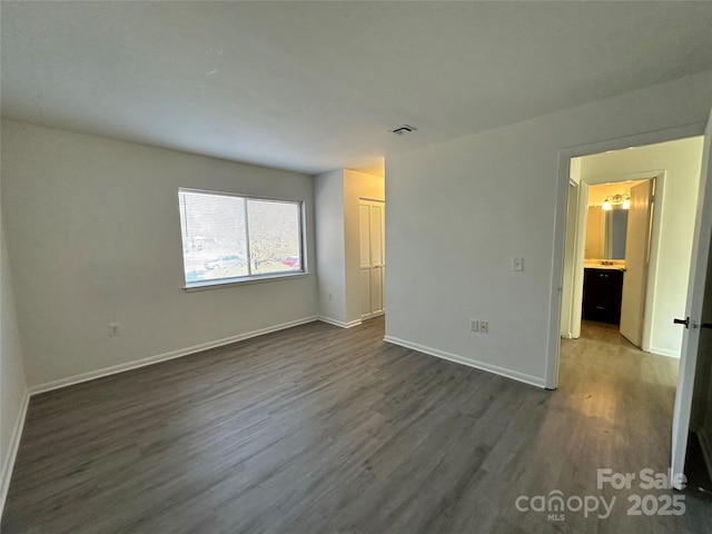 unfurnished bedroom featuring dark wood-type flooring