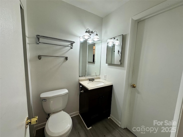 bathroom featuring hardwood / wood-style floors, vanity, and toilet