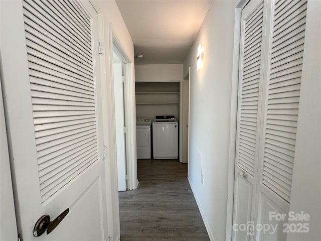 hallway featuring washing machine and clothes dryer and dark hardwood / wood-style floors