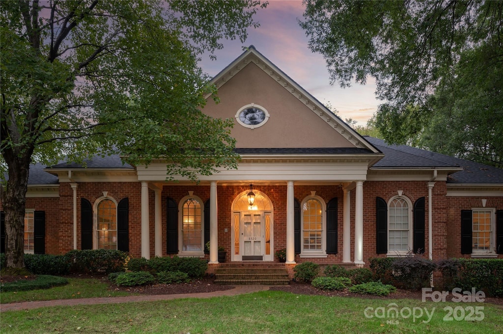 neoclassical / greek revival house with a yard