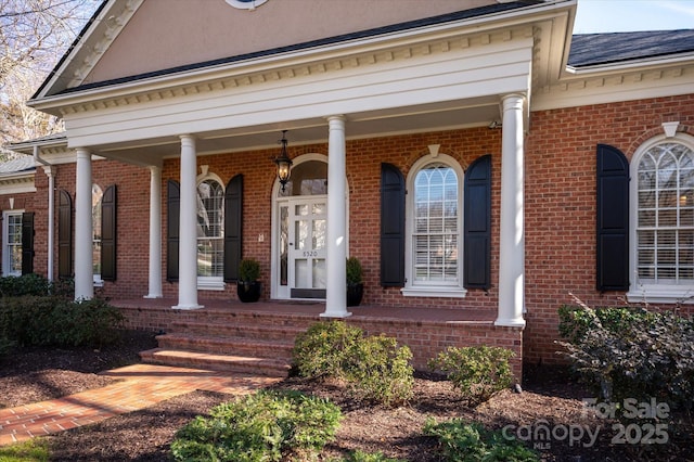 view of exterior entry featuring covered porch