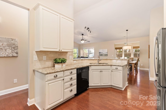 kitchen featuring ceiling fan, black dishwasher, kitchen peninsula, and stainless steel fridge