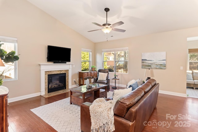 living room featuring ceiling fan, dark hardwood / wood-style floors, high vaulted ceiling, and a fireplace