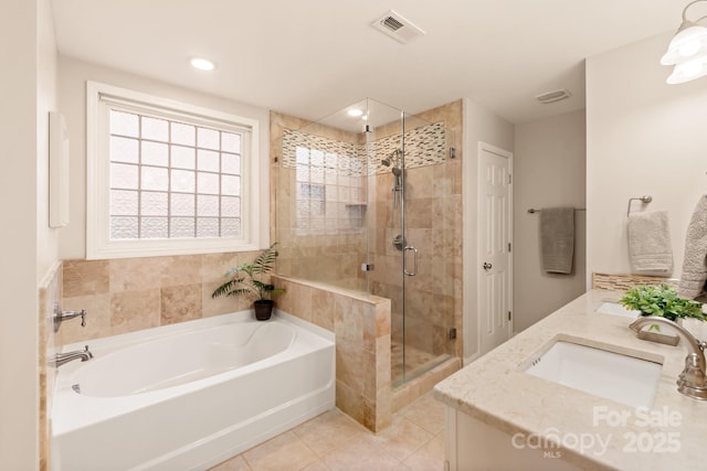 bathroom featuring independent shower and bath, tile patterned floors, and vanity