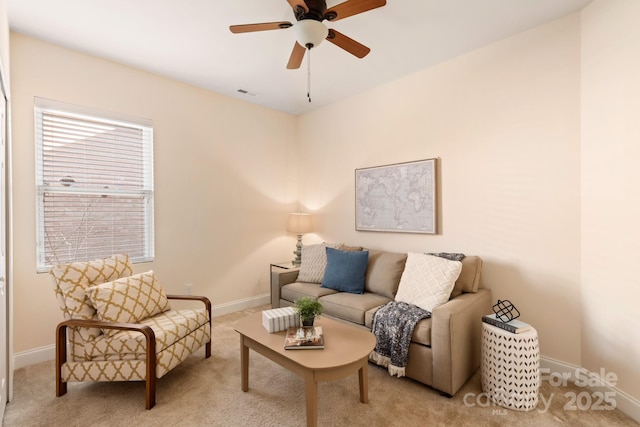 carpeted living room with ceiling fan and a healthy amount of sunlight