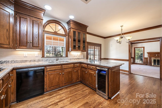 kitchen with sink, a healthy amount of sunlight, beverage cooler, black dishwasher, and decorative backsplash