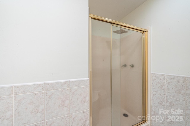 bathroom featuring a shower with door