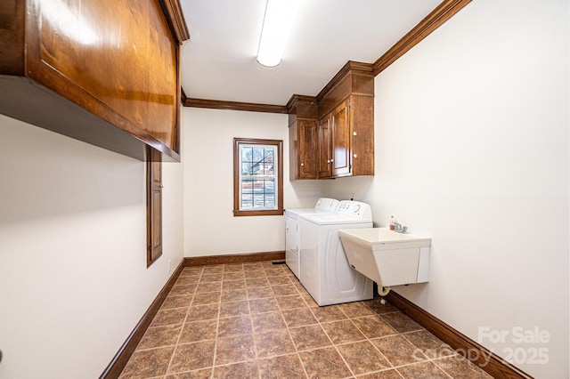 laundry area featuring cabinets, sink, crown molding, and washing machine and clothes dryer