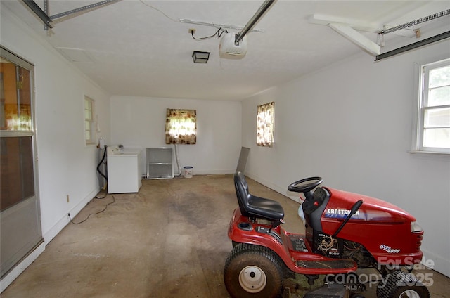 garage featuring washer / dryer and a garage door opener