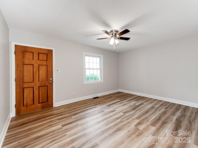 foyer entrance with light hardwood / wood-style floors and ceiling fan