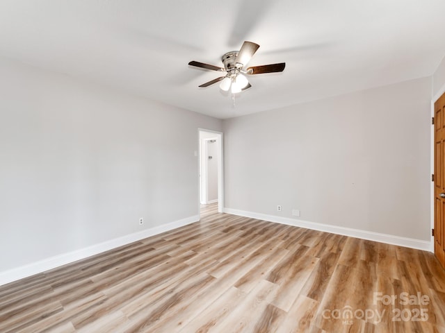 spare room with ceiling fan and light wood-type flooring