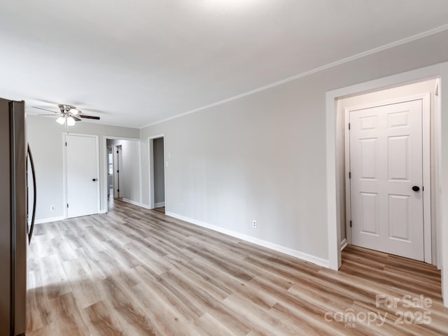 unfurnished living room featuring ornamental molding, light hardwood / wood-style floors, and ceiling fan