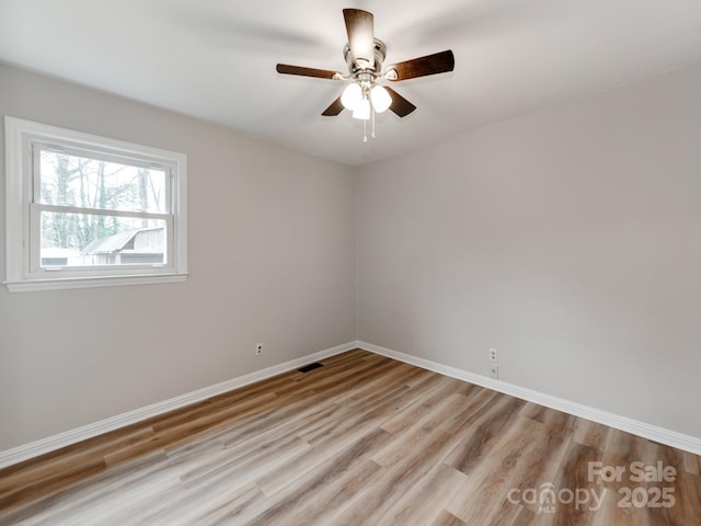 spare room featuring ceiling fan and light hardwood / wood-style floors