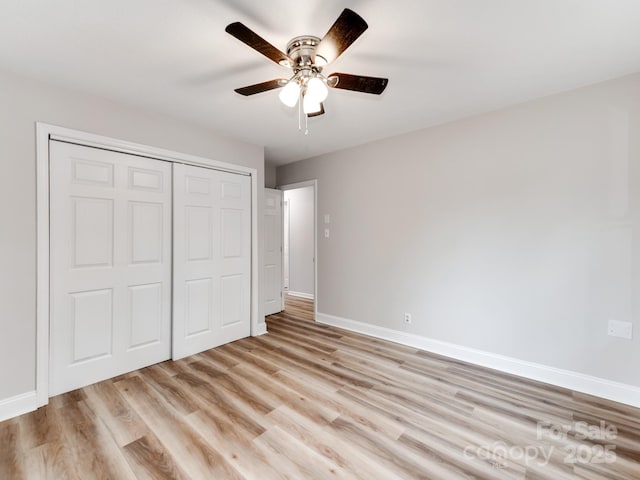 unfurnished bedroom featuring light hardwood / wood-style flooring, a closet, and ceiling fan