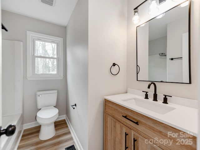 full bathroom featuring shower / bathtub combination, vanity, toilet, and hardwood / wood-style floors