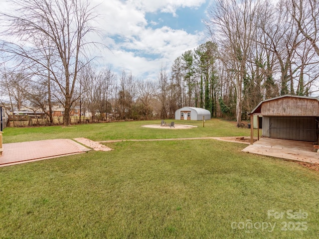 view of yard with a garage and a storage unit