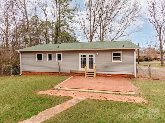 back of house with a lawn and a patio area