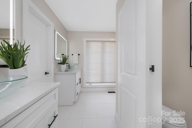 bathroom featuring toilet, vanity, and tile patterned floors