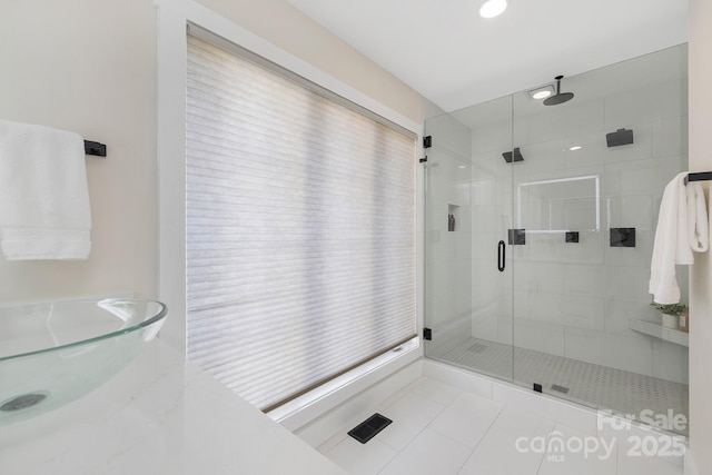 bathroom featuring walk in shower and tile patterned floors