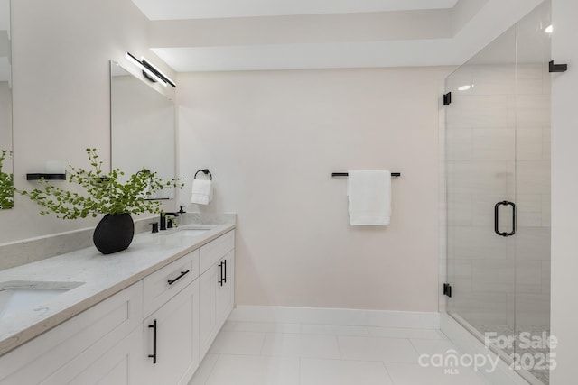 bathroom featuring vanity, tile patterned flooring, and a shower with shower door