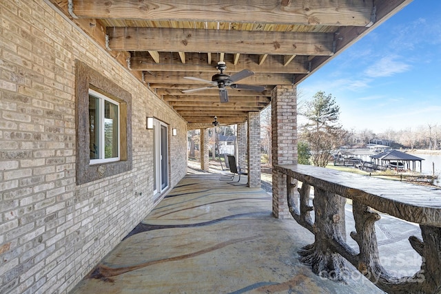 snow covered patio featuring ceiling fan