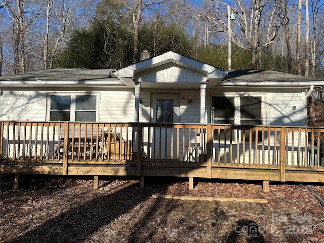 rear view of property featuring a deck