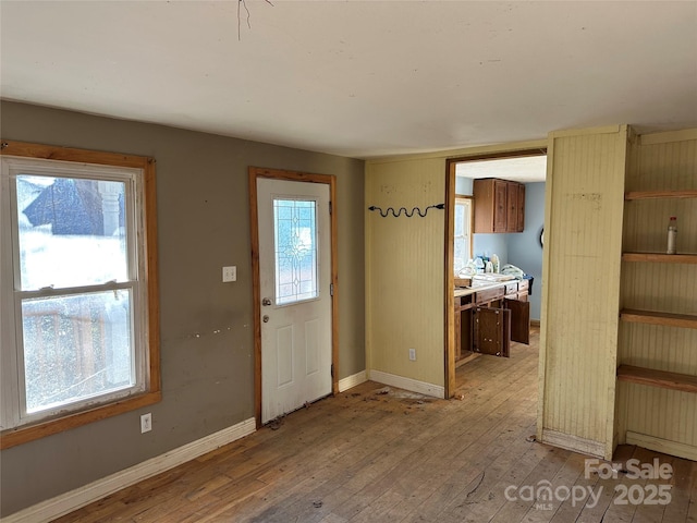 foyer featuring plenty of natural light and light hardwood / wood-style flooring