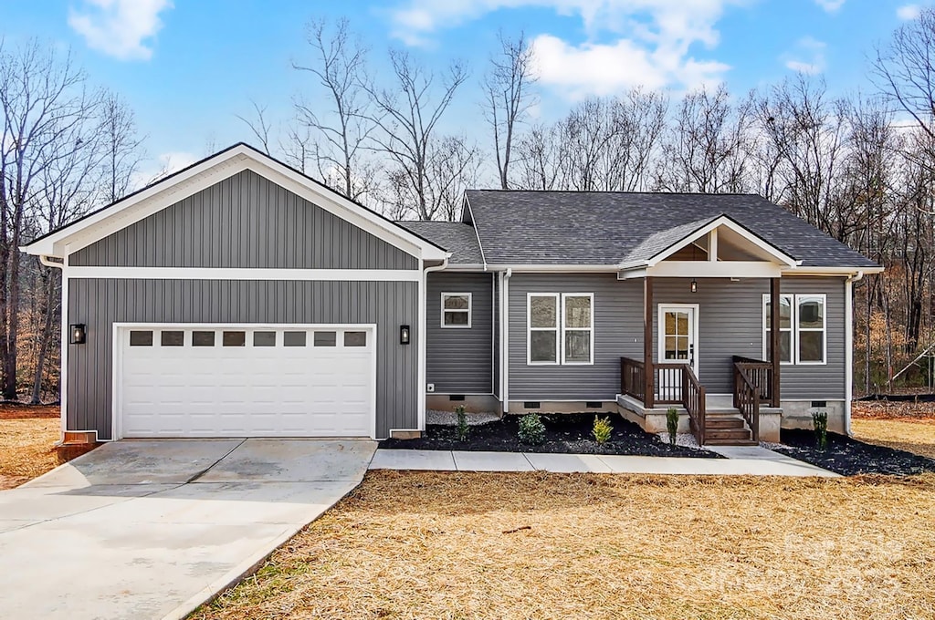 ranch-style house with a garage, concrete driveway, a shingled roof, and crawl space