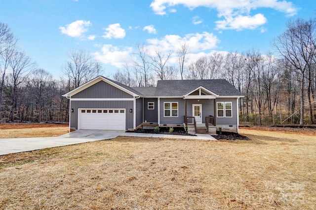 view of front of home with roof with shingles, concrete driveway, an attached garage, a front yard, and crawl space