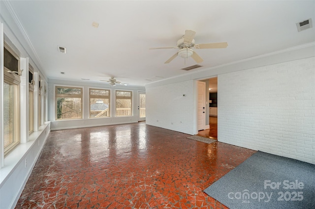 unfurnished living room with brick wall, ceiling fan, and crown molding