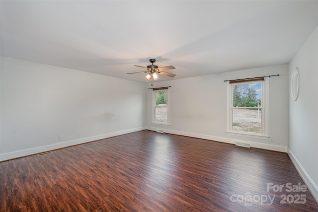 empty room featuring ceiling fan and dark hardwood / wood-style flooring