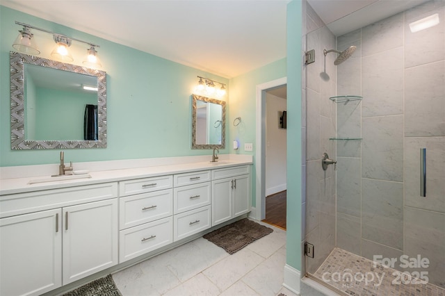 bathroom with walk in shower and vanity