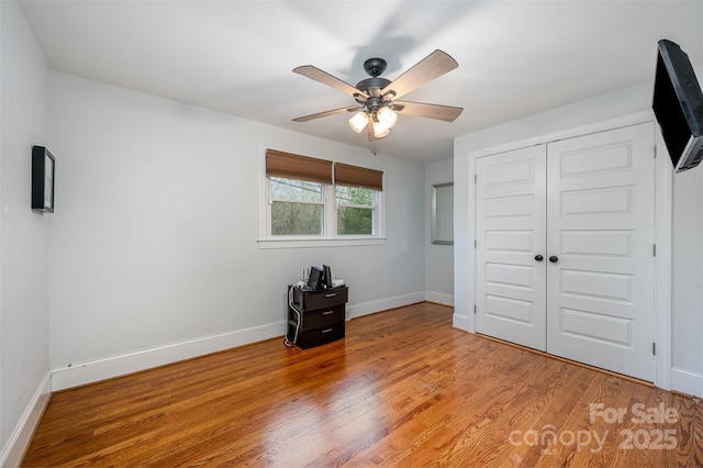 unfurnished bedroom featuring a closet, ceiling fan, and hardwood / wood-style flooring