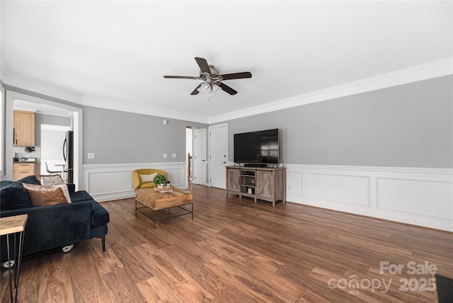 living room featuring hardwood / wood-style flooring and crown molding