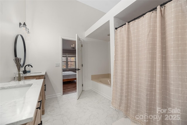 bathroom featuring vanity and a washtub