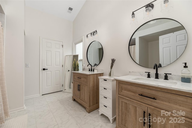 bathroom with vanity and vaulted ceiling